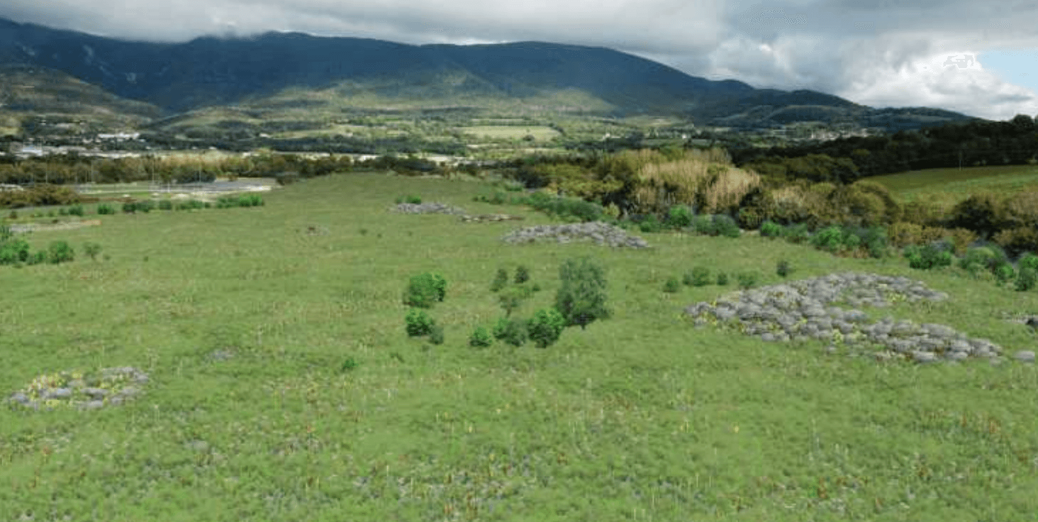 Photomontage officiel du site remis en état : prairie verte, bosquets, Jura en arrière-plan